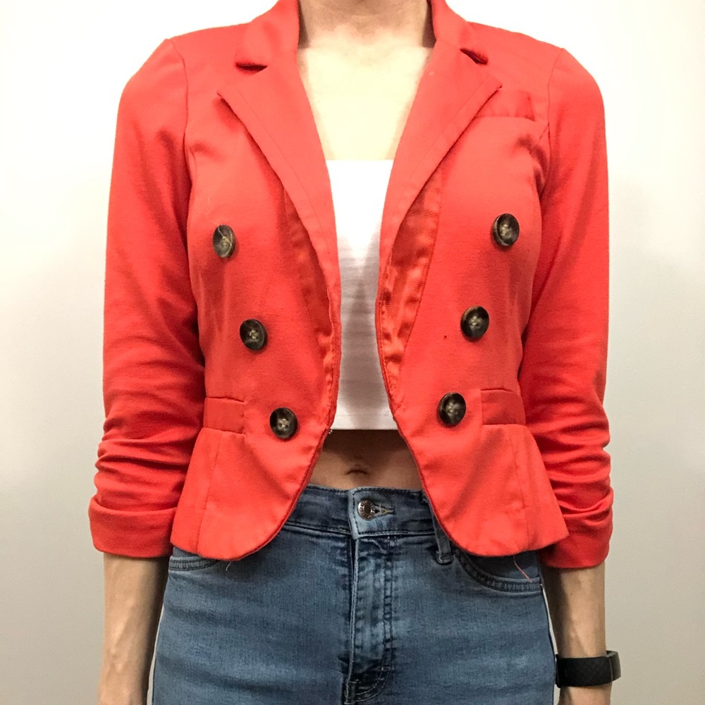 Double breasted orange blazer.